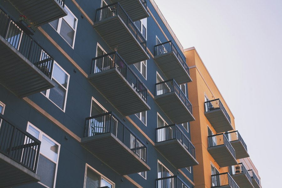 Balconies on a blue and orange mid-rise condo building