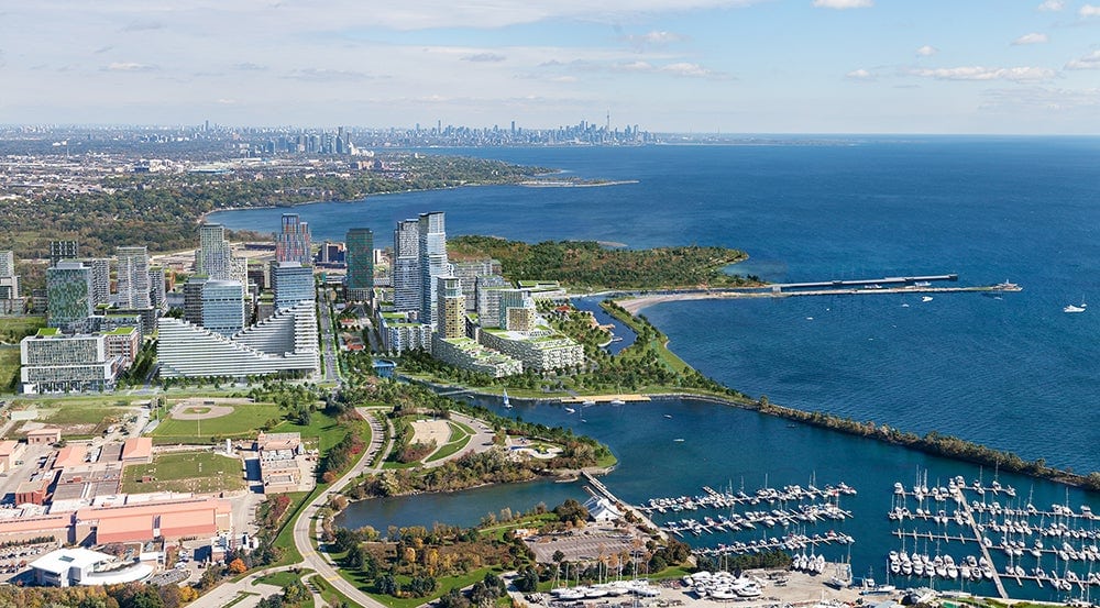 Aerial rendering of the Lakeview Village master-planned waterfront community in Mississauga, with the marina, pier and Toronto skyline beyond